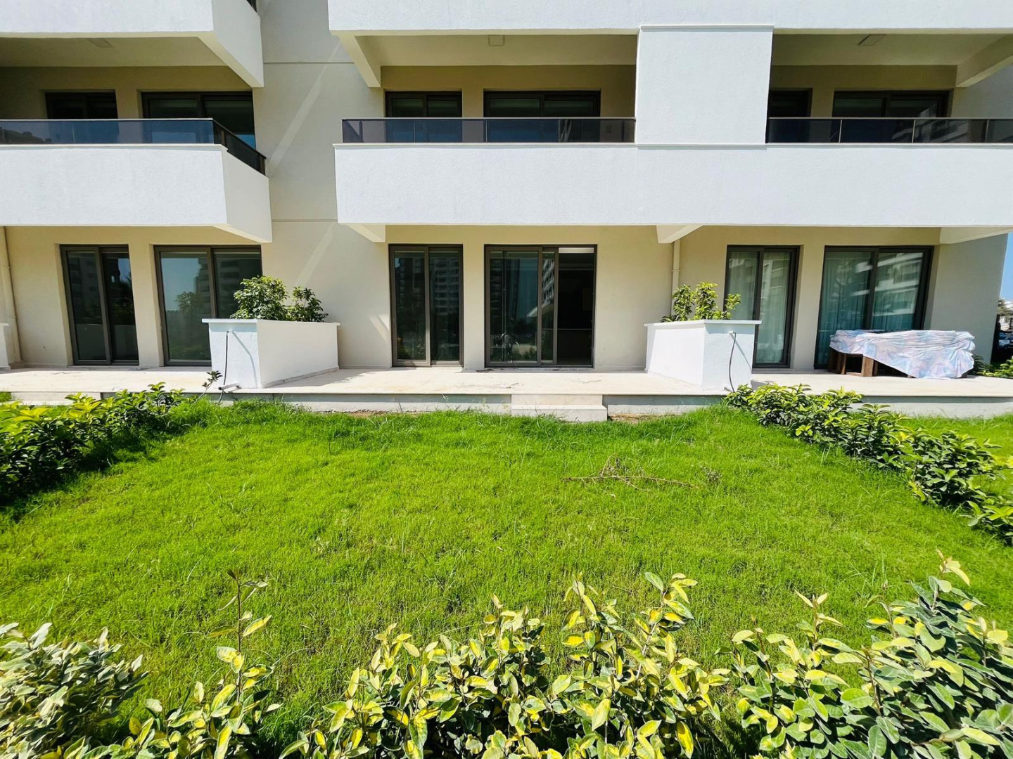 MB Azure Resort 1+1 Bahçe Katı – bahçe katı dairelerin önündeki peyzaj